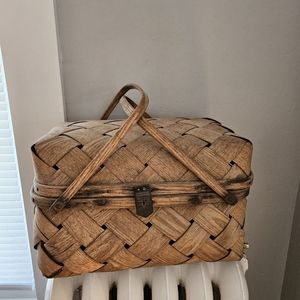 Antique woven basket with leather closure